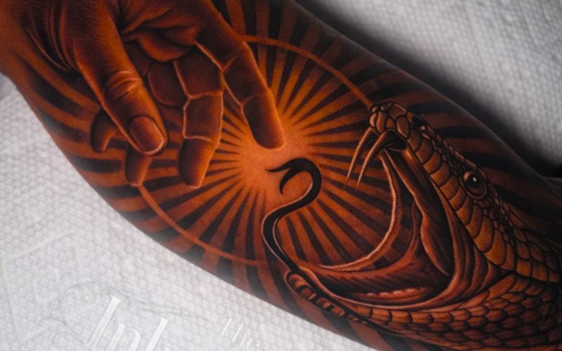 J tattooing a client